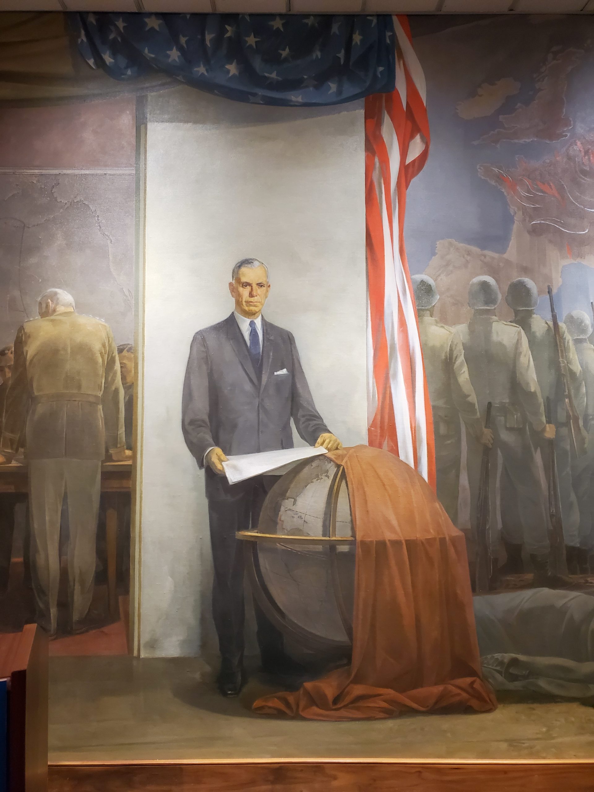 Mayer explained that, while the central figure looks like General Marshall, it is not meant to be a portrait. It is the picture of a Statesman.