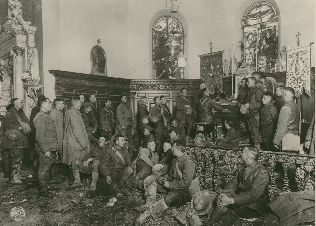 Men of the 80th Blue Ridge Division sing in a church, Vaux, France, November 5, 1918.
