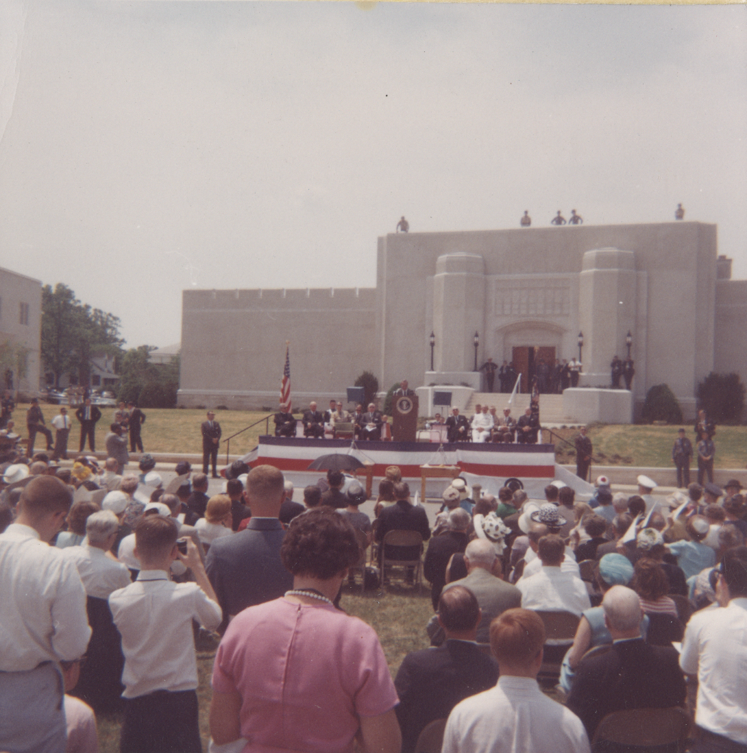 Speaker at podium, building dedication