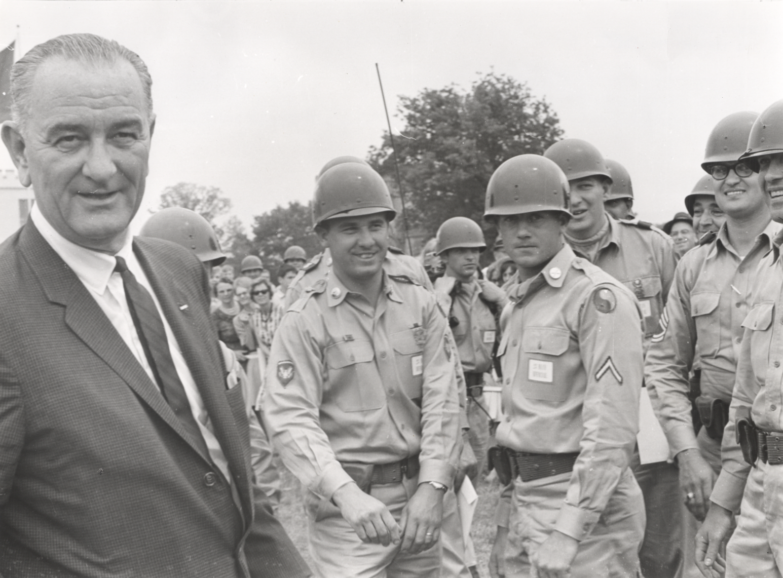 President Lyndon B. Johnson with his Army entourage after his arrival at the dedication of the George C. Marshall Research Library, May 23, 1964. The soldiers shown are from the Virginia National Guard's 29th Infantry Division.