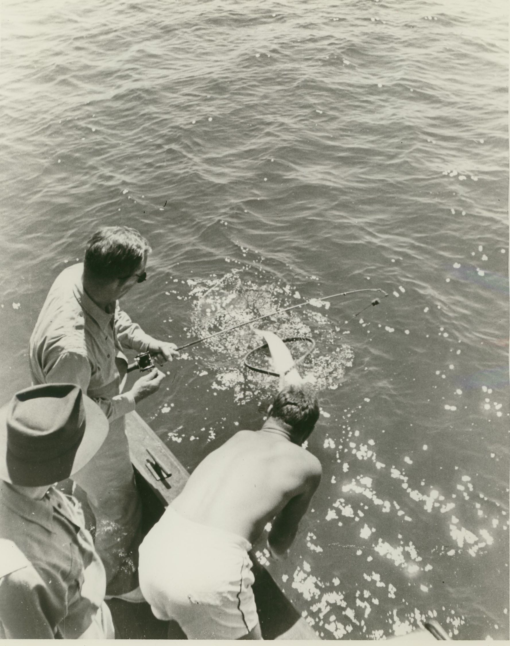 George Marshall fishing from a boat ...