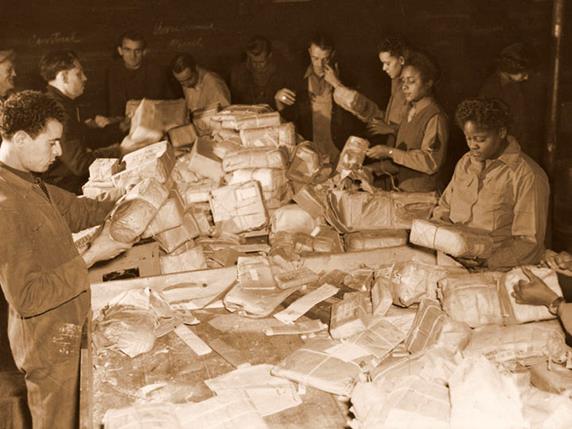 Members of the 6888th working with French civilians and German prisoners of war in Rouen. Center of Military History photo.