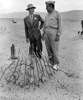 J. Robert Oppenheimer and Maj. Gen. Leslie Groves at the Trinity site September 1945. Groves is shown wearing shoe coverings to prevent carrying radioactive material. (Atomic Archive photo)