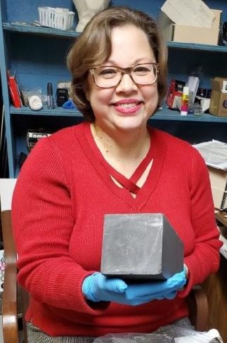 Library and Archives Director Melissa Davis holding one of the graphite bars from Pile-1.