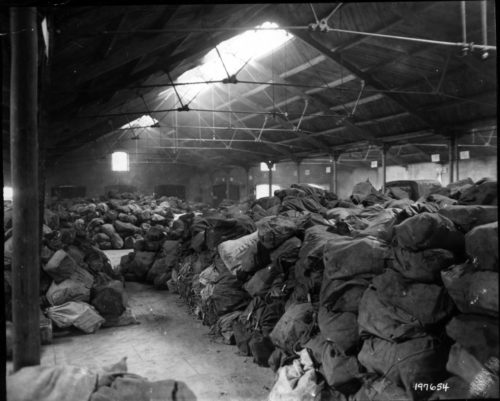 Airplane hangar in Birmingham, Eng., filled with mail and packages. Women of the 6888th photo