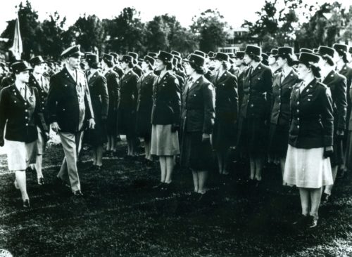 Gen. George Marshall reviewing WAC troops at Ft. Oglethorpe, GA. Enlisted WAC personnel wore dark skirts; the officers wore light-colored skirts.
