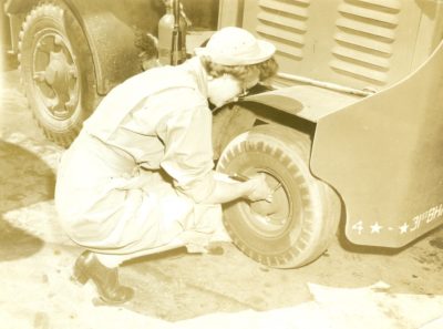 Tightening lug nuts in the motor pool at March Field. Note the WAC oxfords.