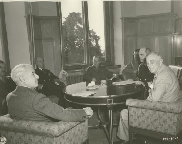 Secretary Stettinius, Gen. Kuter, Adm. King, Gen. Marshall, Adm. Leahy, and President Roosevelt meeting around a table at Livadia Palace.