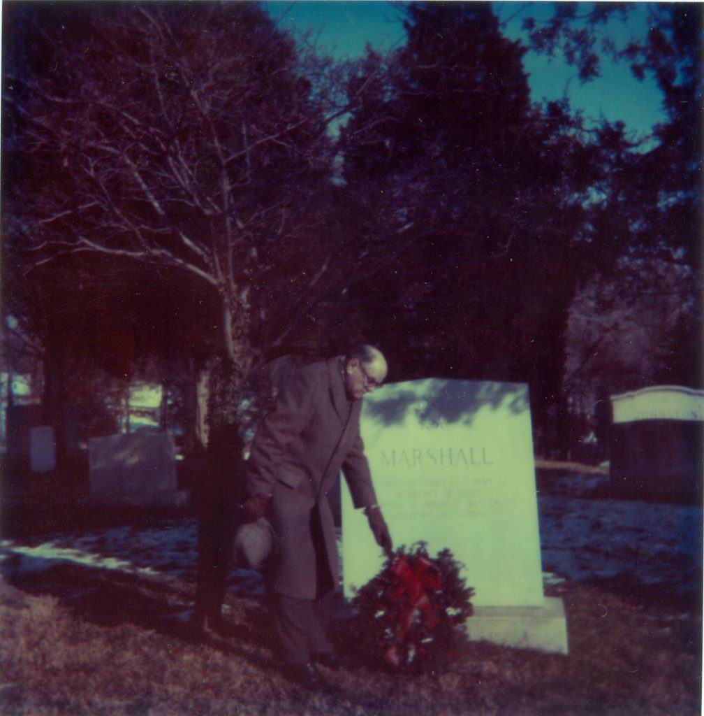 Dr. Forrest C. Pogue leaves a wreath at Marshall's grave, date unknown.