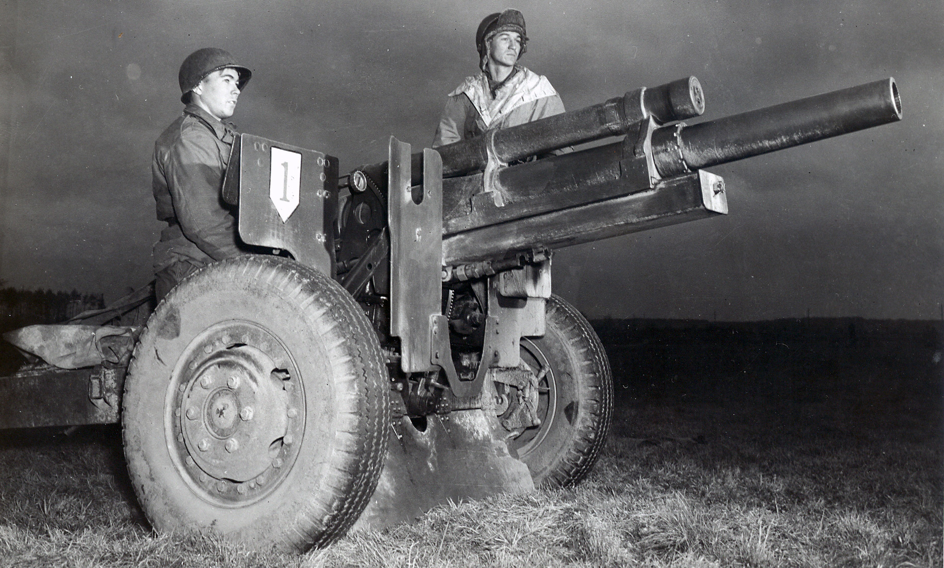 Two men stand ready to fire 105-mm howitzer during Operation Snowdrop in January 1949.