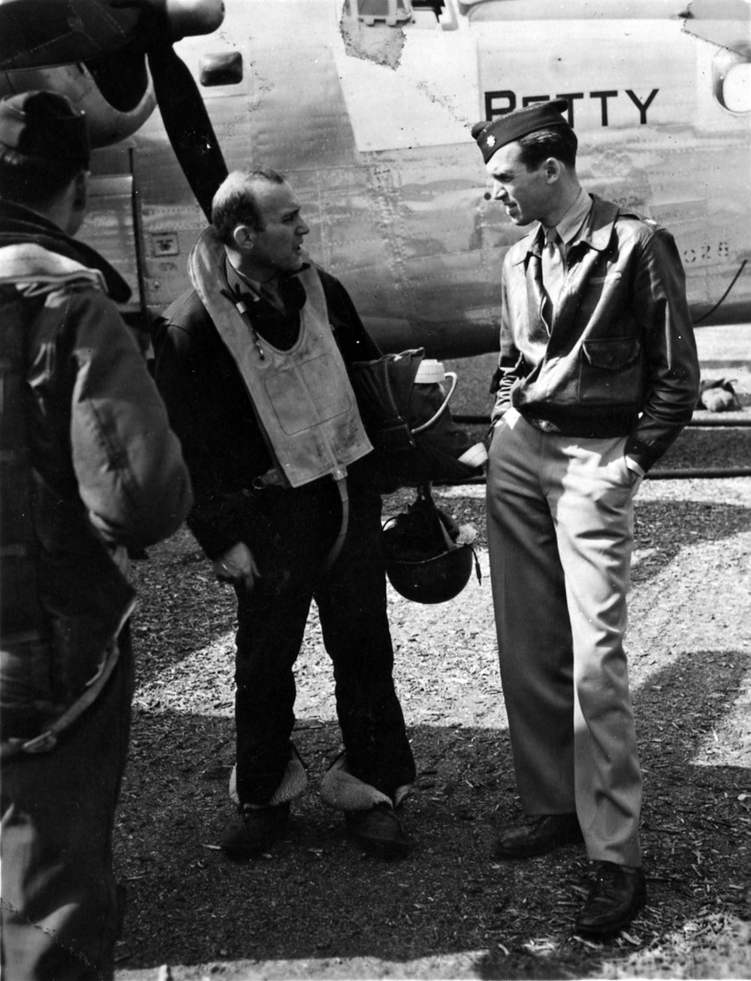 Maj. Jimmy Stewart confers with a B-24 crew member. U.S. Air Force photo. Public domain.